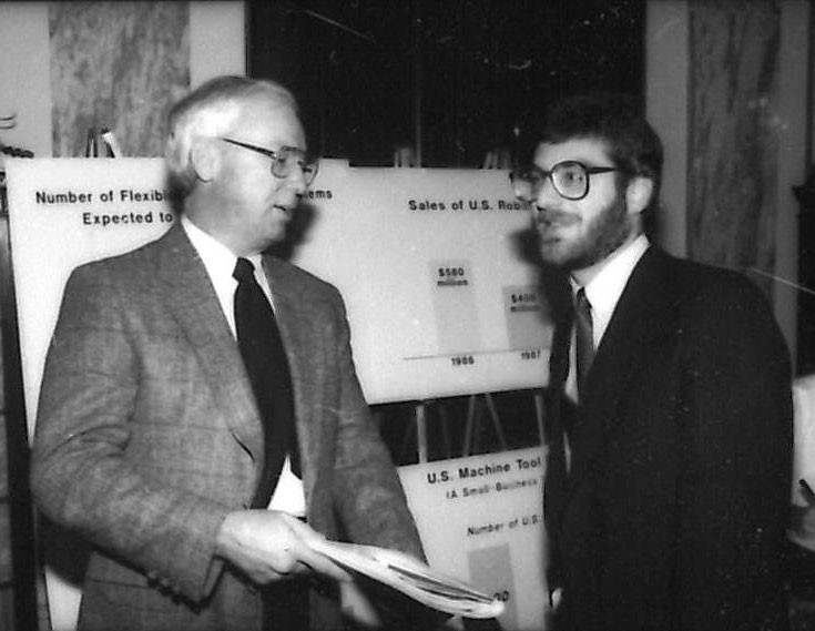 The first president of what was to become known as the Association for Advancing Automation, Don Vincent (at left), and Jeff Burnstein, who took over the role in 2007 and still leads A3 today, discuss robot sales back in 1987.