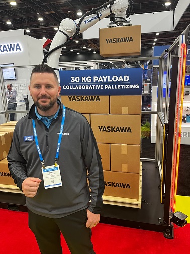 Chris Caldwell, product manager with Yaskawa Motoman, at Automate with a new, larger payload cobot aimed at palletizing. 