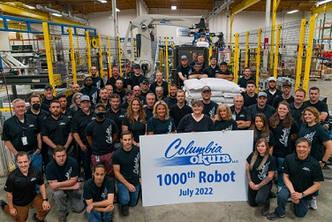 Over the past 26 years, the team has gathered for every one-hundred robot sold milestone, celebrating with lunch and a team photo with the robot.