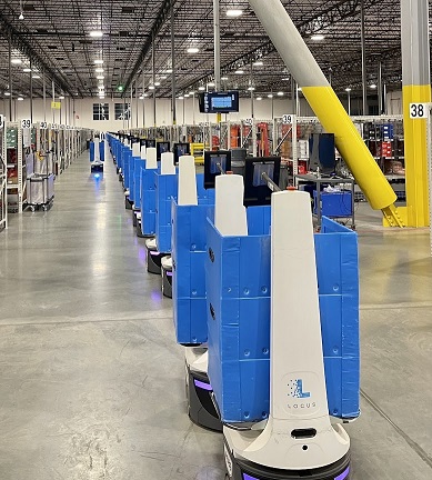 A line of LocusOne mobile robots ready for action. The bots make human pickers more productive by keeping walking to a minimum and maximizing value-added picking time.