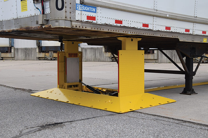A ground-mounted trailer stand raises and retracts with the push of button.