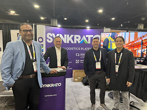 The Synkrato team in their booth, demonstrating their new logistics platform. 