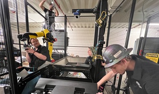 Working with a FANUC robot and a Pregis automated bagging machine, OSARO staff members collaborate with NPSG Global technicians to construct OSARO Robotic Bagging System cells at Zenni Optical in Novato, California.