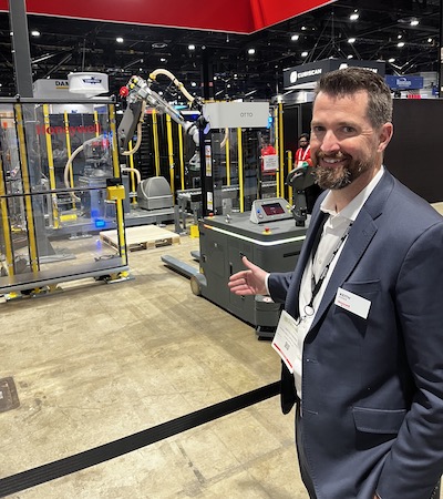 Keith Fisher, president of Honeywell Intelligrated, with the company’s Smart Flexible Depalletizer solution, which can work in concert with AMR lift trucks (an Otto vehicle featured in the ProMat demo).
