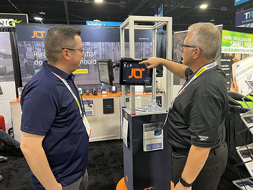 Jason Joiner, field application engineer (left) and Eric Miller CEO (right) discuss the JLT1214 vehicle-mount computer. 